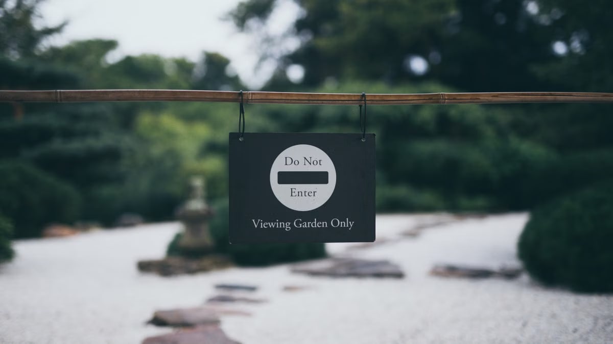 Peaceful garden scene with 'Do Not Enter' sign, promoting serenity and exclusivity.
